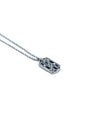 Close up of dog tag pendant with black sapphires and diamonds. 