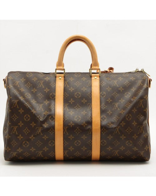 Dark brown Louis Vuitton bag with iconic pattern, tan handles, and gold hardware.