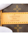 Tan Louis Vuitton leather tag on bag.