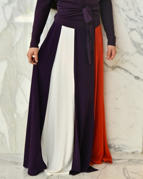 Model wearing silk crepe skirt in white, purple, and red. 