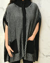 Model posing in Cable Knit Cape.