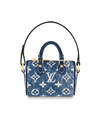 Denim blue Louis Vuitton print bag charm with gold hardware and leather handles.