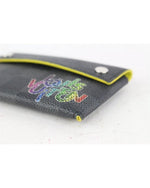 Close up of rainbow Louis Vuitton branding on corner of card case.