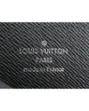 Close up of Louis Vuitton silver branding in leather.