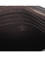 Close up of slightly-faded Louis Vuitton branding inside of pouch.