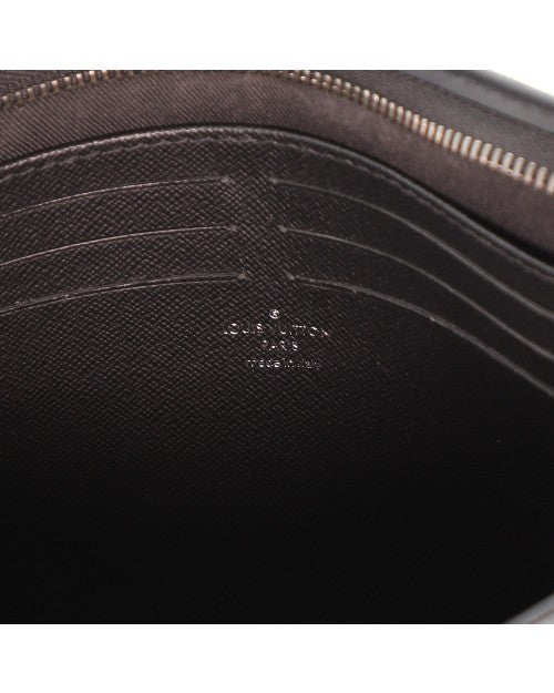 Close up of slightly-faded Louis Vuitton branding inside of pouch.