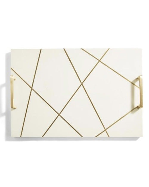 Birds-eye view of white tray with gold brass handles.