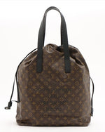 Brown bag with Louis Vuitton print and dark brown leather handles.