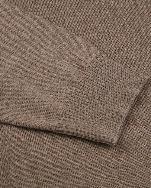 A close-up view of brown fabric with a ribbed wrist cuff laid on top.