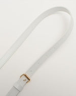 Close up on adjustable white shoulder strap.