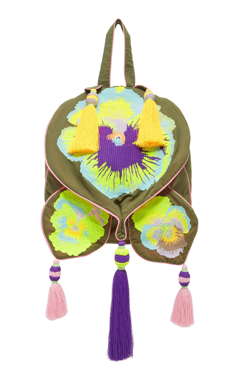 Olive green backpack with floral embroidery and tassels decorating the backpack. 