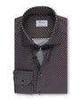 An overhead view of a folded button-down shirt featuring a small, intricate geometric pattern, and a chest pocket with two buttons. The shirt has a white square label inside the collar that reads "Stenströms" and 'Crafted to perfection.