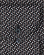 Fabric with a small, intricate geometric pattern, and a pocket with two black buttons. 