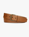 Tan belt with brass buckle in front of white background. 
