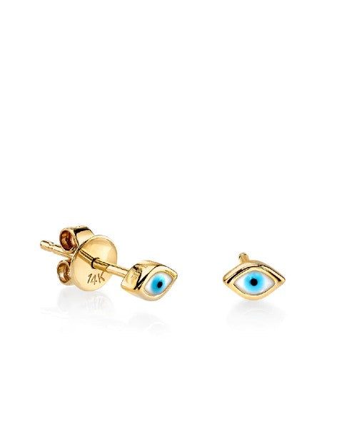 Gold stud earrings with blue evil eye in front of white background.