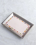 Jewelry Tray placed on white marble surface. 
