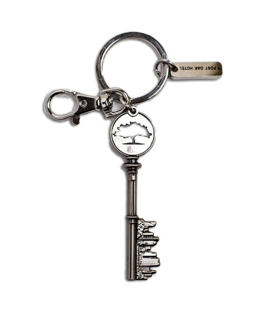 Keyring with silver key that has Post Oak logo and Houston skyline. 