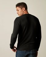 Model facing away from camera to show back of Soren Sweater.