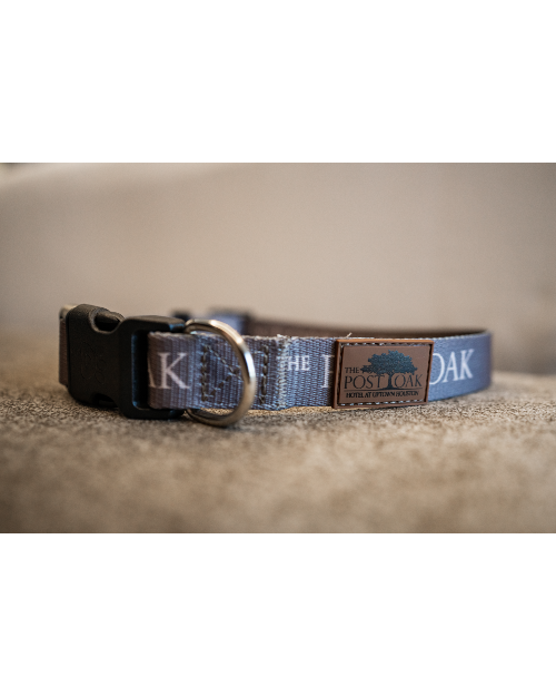Close up of The Post Oak dog collar with brown leather Post Oak logo tag.