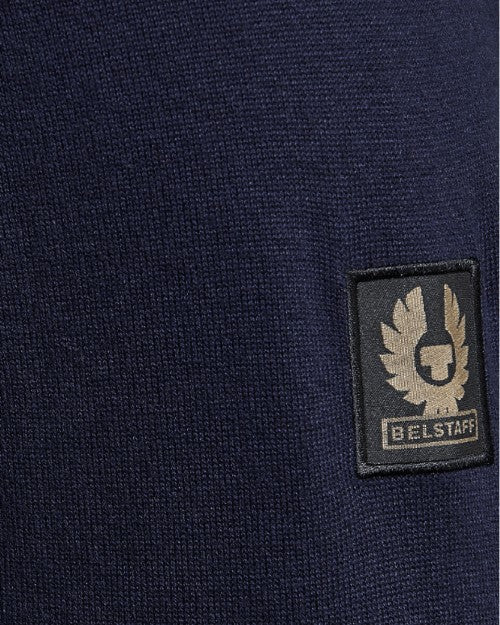 Close up of tan and black Belstaff logo patch on sleeve.