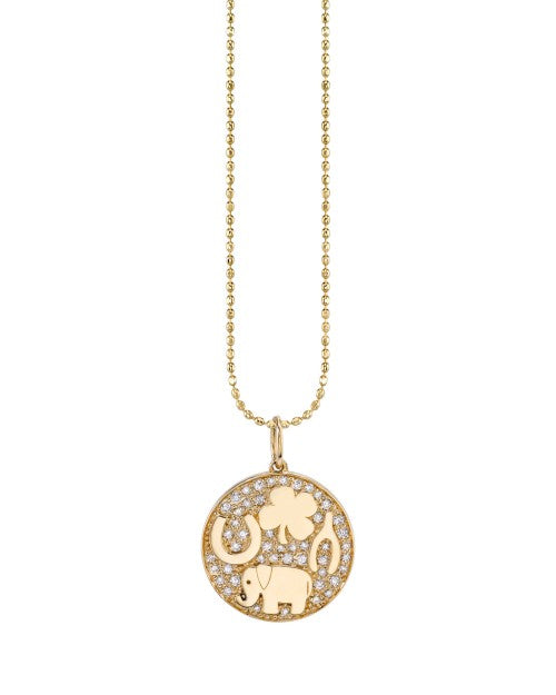 Gold necklace with diamond medallion charm designed with common signs of good luck. 